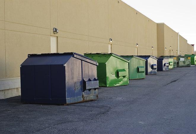 a forklift lifts a full dumpster from a work area in Anaheim